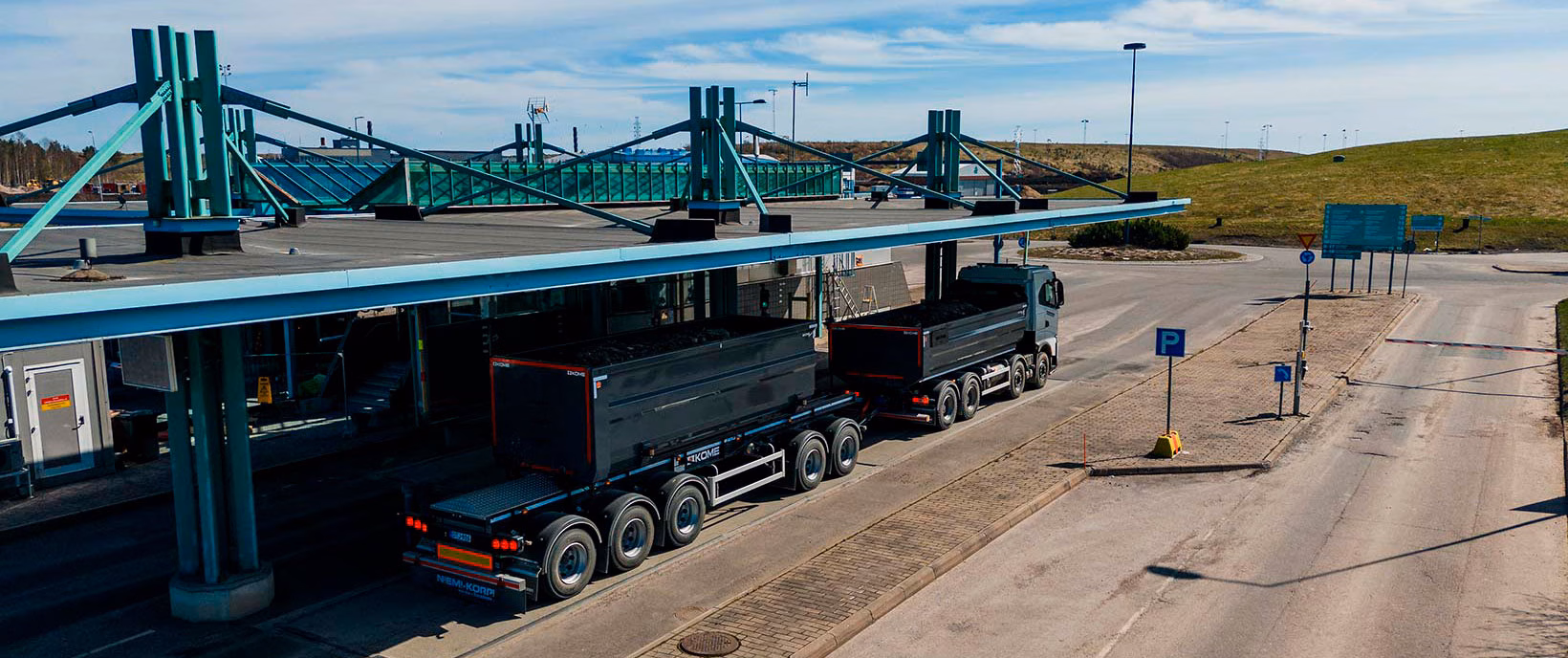 Truck on a truck scale under a canopy at a weighing station