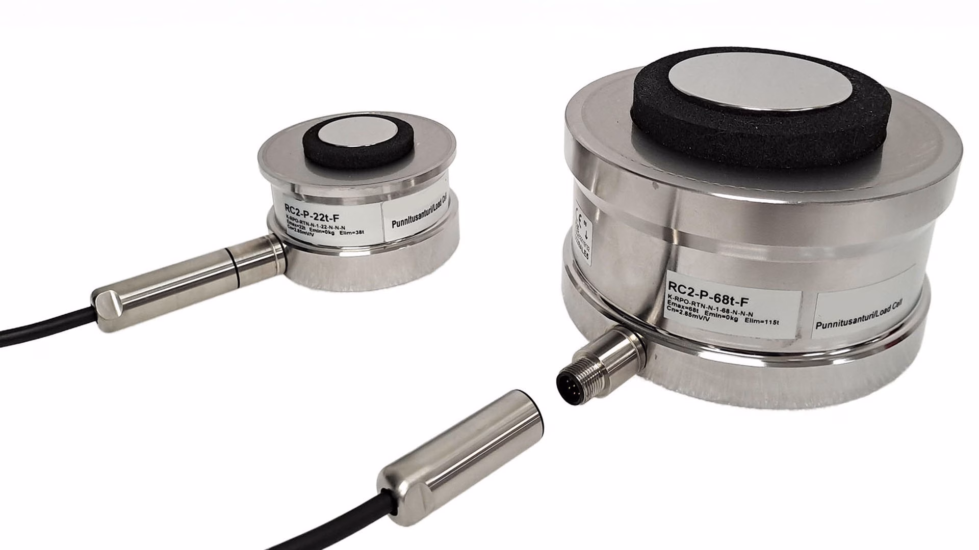Two metal load cells on a white background