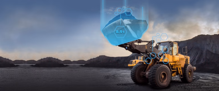 Wheel loader weighing material in a quarry with digital load data display (8.9 t)