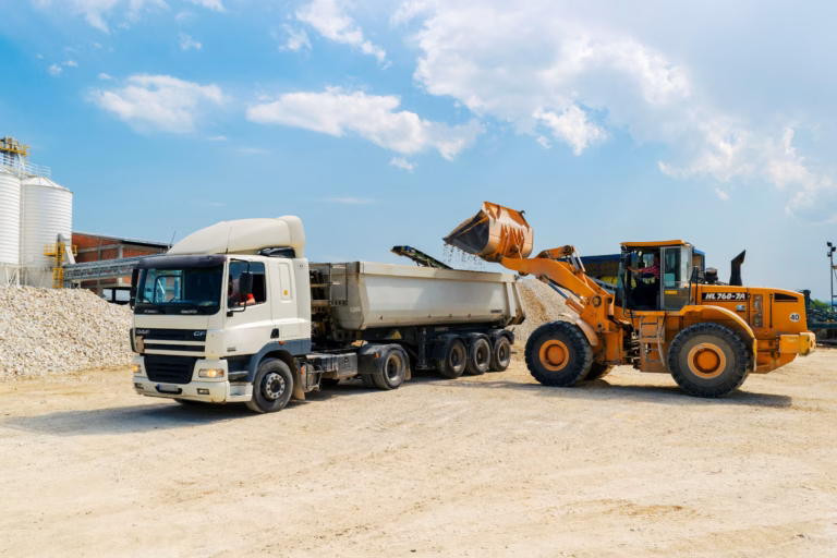 Wheel loader loading gravel into a dump truck at a construction site