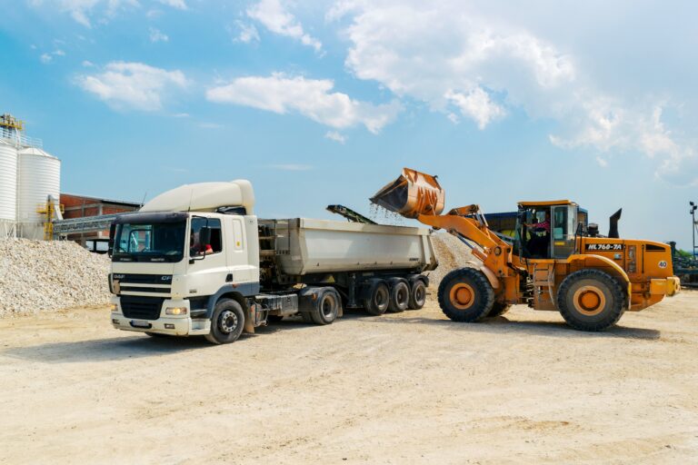 Wheel loader loading gravel into a dump truck at a construction site