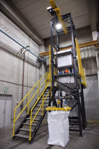 Big bag unloading station for bulk material handling in an industrial environment