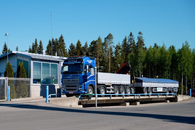 Truck on a surface-mounted concrete truck scale in an industrial yard