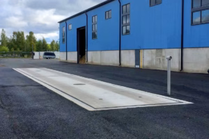 Pit-mounted concrete truck scale in an industrial yard