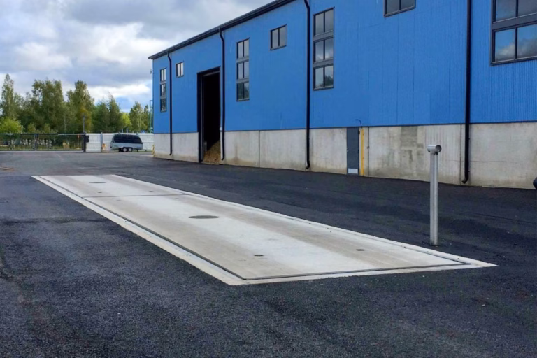 Pit-mounted concrete truck scale in an industrial yard